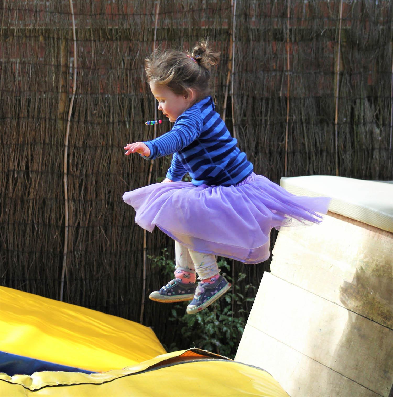 Child jumping off obstacle course
