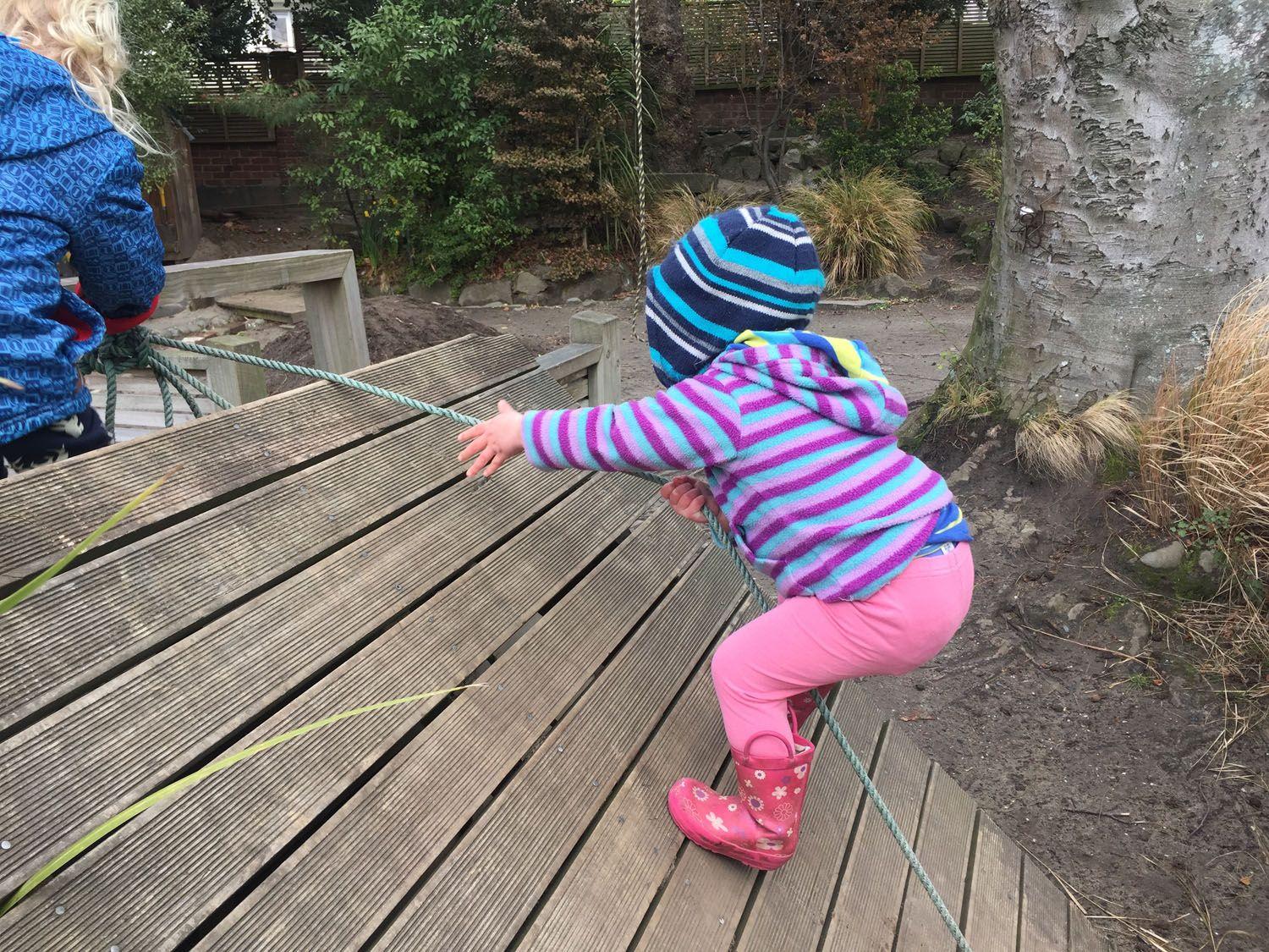 Child climbing rope wall